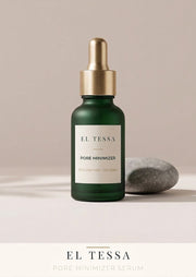 EL TESSA pore minimizing serum in a green glass dropper bottle with a gold dropper, standing beside a grey stone