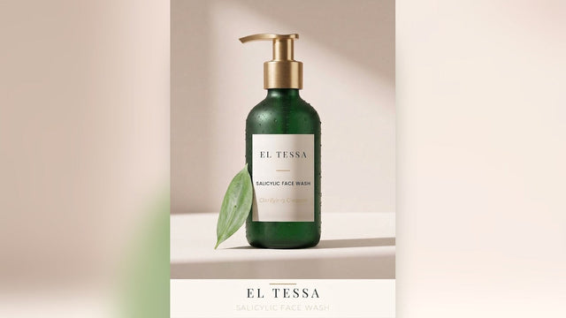 Green EL TESSA Salicylic Face Wash pump bottle with a green leaf on a beige table