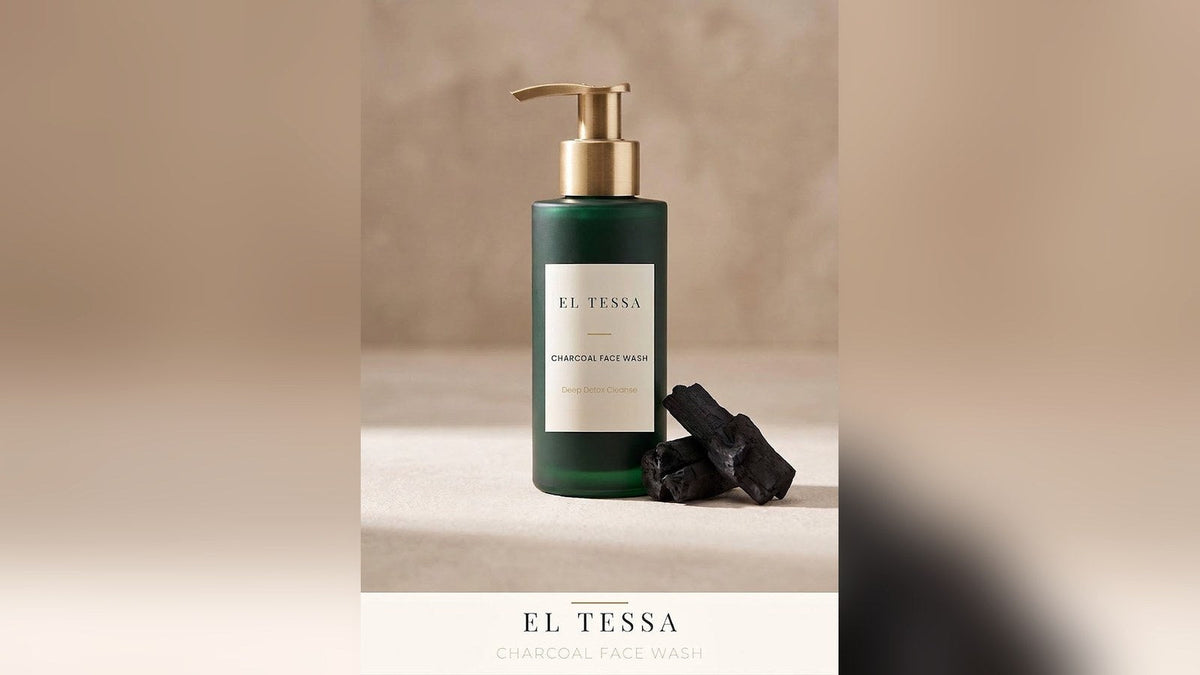 Green EL TESSA Charcoal Face Wash pump bottle beside pieces of charcoal