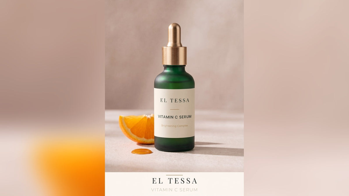 Green EL TESSA Vitamin C Serum dropper bottle beside a slice of orange