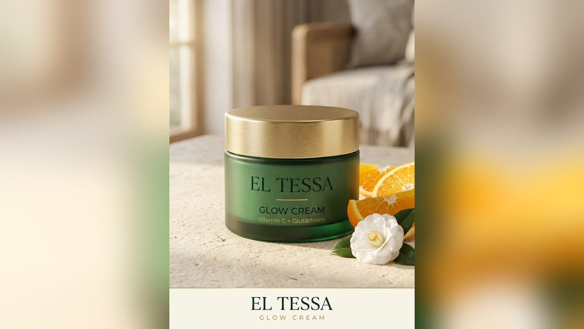 EL TESSA Glow Cream jar with vitamin C and glutathione, beside orange slices and a white flower