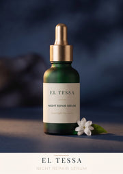 EL TESSA Night Repair Serum for Dull, Tired Skin, a green dropper bottle with a gold cap beside a white flower