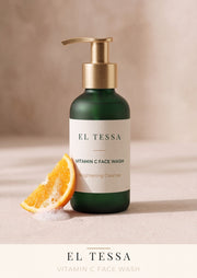 EL TESSA Vitamin C Face Wash for Dull Skin in a green pump bottle labelled Brightening Cleanse, beside an orange slice and foam